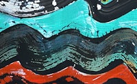 a close up of a painting with waves on it