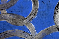 a painting of blue and black circles on a blue background